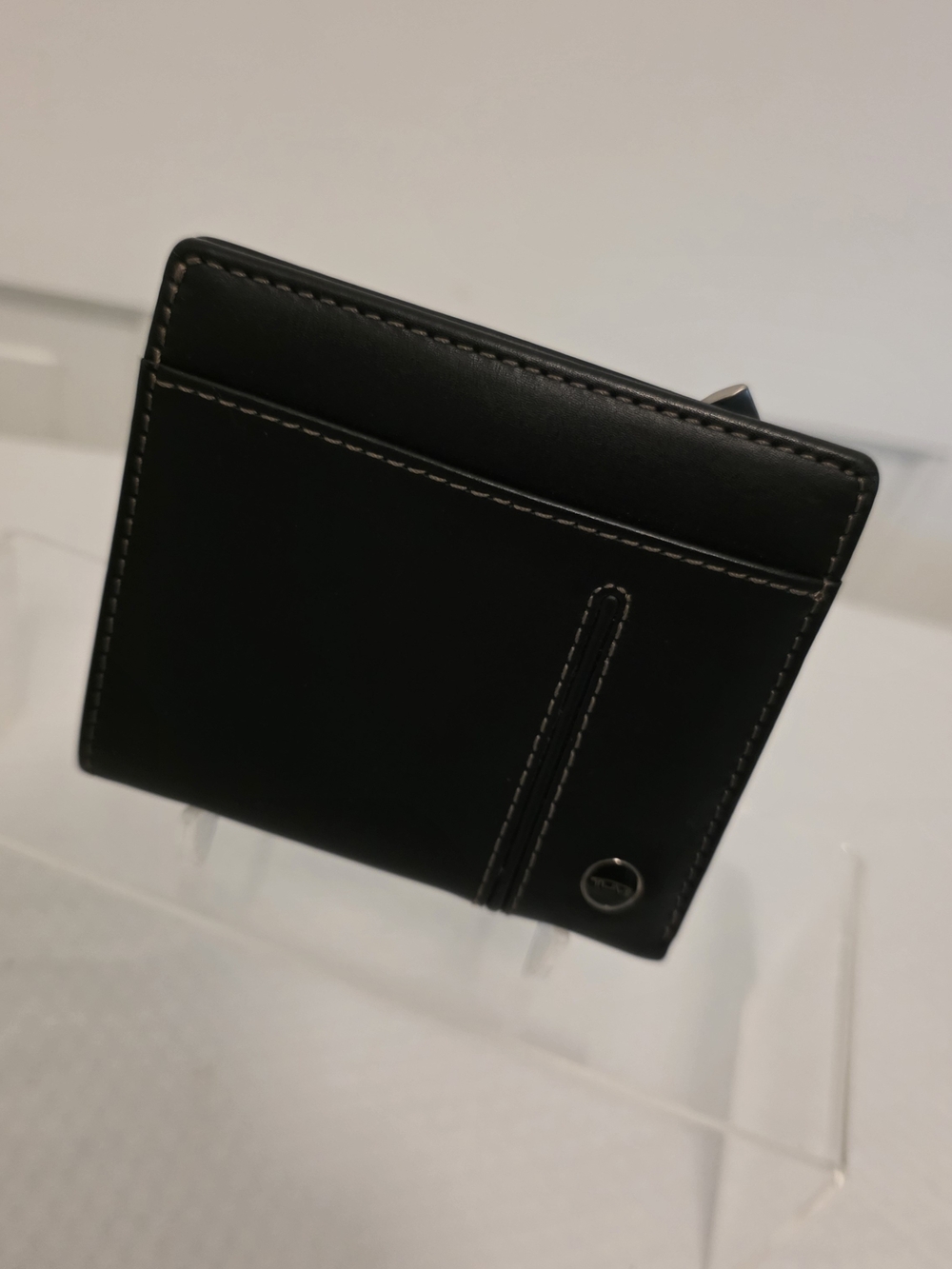 Tumi Black Leather Bi-Fold Wallet with Contrast Stitching and Metal Accent